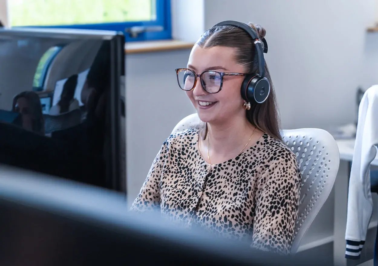 Liv with headphones looking at screen